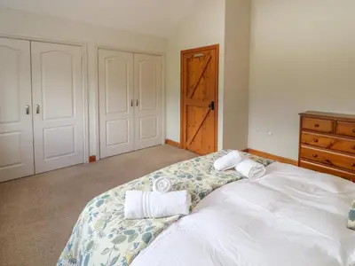 a bedroom with a bed with towels on it at Gallery Cloisters in Keswick