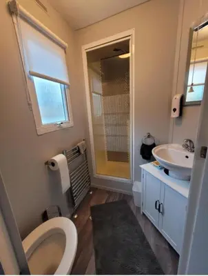 a bathroom with a toilet and a sink at Cairnryan Heights home from home in Cairnryan