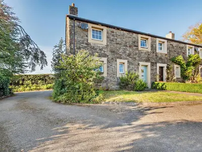 an old stone house with a gravel driveway at 3 Bed in Workington oc-92628 in Dean