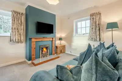 a living room with a couch and a fireplace at 3 Bed in Workington oc-92628 in Dean
