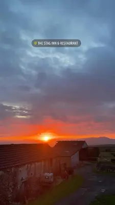a sunset over a barn with the words the stage inn is restaurant at Room with Newly Renovated Private Bathroom above Village Pub Stag Inn Crosby Maryport in Maryport