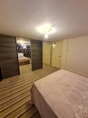 a bedroom with a large bed and a mirror at Douglas Head Road in Douglas