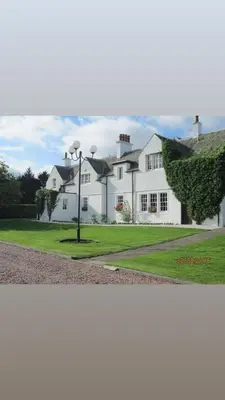 a white house with a street light in front of it at Brig o Doon House Alloway in Ayr