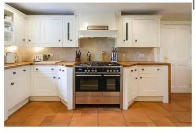 a kitchen with white cabinets and a stove at Brig o Doon House Alloway in Ayr