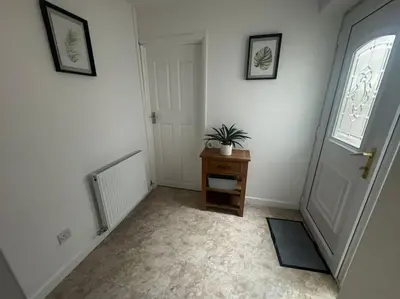 a hallway with a door and a plant on a table at Lonsdale Terrace - 3 Bedrooms - Sleeps 6 in Workington