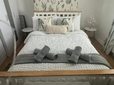 a large bed with four pillows on it at Lonsdale Terrace - 3 Bedrooms - Sleeps 6 in Workington