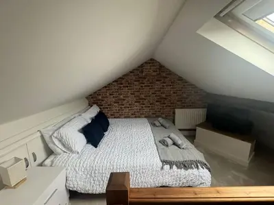 a bedroom with a bed in a attic at Lonsdale Terrace - 3 Bedrooms - Sleeps 6 in Workington