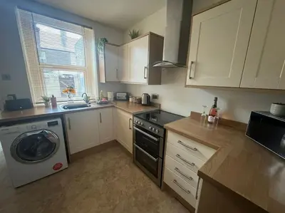 a kitchen with a washing machine and a washer at Lonsdale Terrace - 3 Bedrooms - Sleeps 6 in Workington