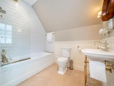 a bathroom with a toilet and a sink and a tub at Lundin Links - Ukc6916 in Turnberry