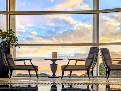 a room with two chairs and a table in front of a large window at Lundin Links - Ukc6916 in Turnberry
