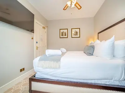 a bedroom with a large white bed and a window at Lundin Links - Ukc6916 in Turnberry