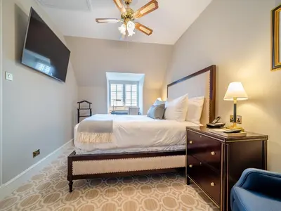 a bedroom with a bed and a flat screen tv at Lundin Links - Ukc6916 in Turnberry