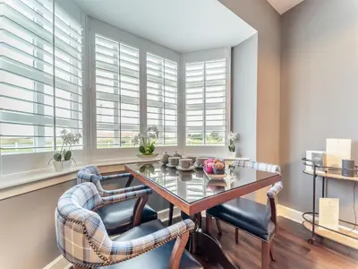 a dining room with a table and chairs and windows at Royal Dornoch - Ukc6918 in Turnberry