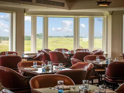 a restaurant with tables and chairs and large windows at Royal Dornoch - Ukc6918 in Turnberry