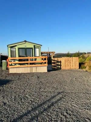 a tiny house sitting on top of a pile of gravel at Maneight Fir View with hot tub in Dalleagles