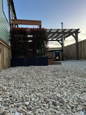 a stone patio in front of a building at Maneight Fir View with hot tub in Dalleagles
