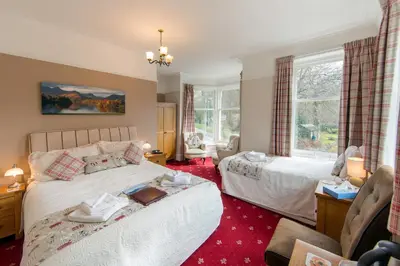 a bedroom with two beds and a window at Laurel Bank Guest House in Keswick
