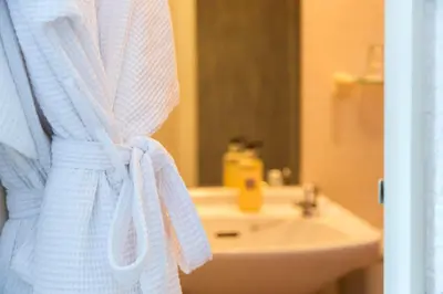 a bathroom with a white towel hanging next to a sink at Laurel Bank Guest House in Keswick