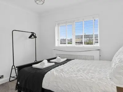 a bedroom with a bed with two towels on it at Modern & Stylish 2 Bed Home in Whitehaven in Whitehaven