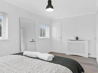 a white bedroom with a large bed with two pillows at Modern & Stylish 2 Bed Home in Whitehaven in Whitehaven