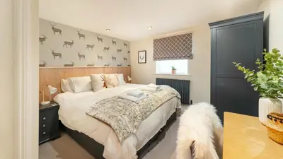 a bedroom with a bed and a dog in it at Derwentwater View in Portinscale