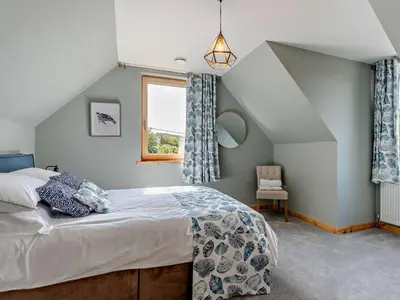 a bedroom with a bed and a window at 4 Bed in Kippford 95234 in Kippford
