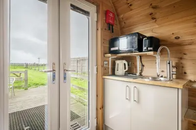 a kitchen with a sink and a microwave at Unit 2 - Carrock View Camping Pod in Carlisle