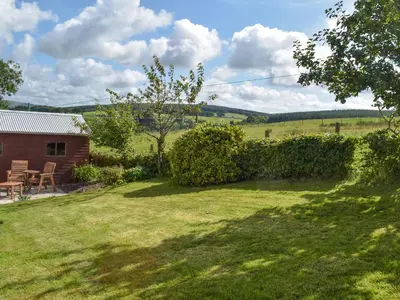 a view of a yard with a house at Lilybank Cottage in Doularg