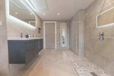 a large bathroom with a sink and a shower at Luxury townhouse in Workington in Workington