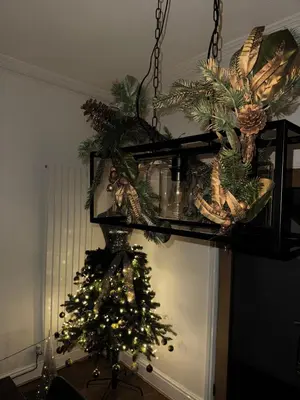 a christmas tree in a room with a chandelier at Luxury townhouse in Workington in Workington