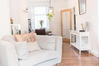a living room with a white couch and a table at Luxury townhouse in Workington in Workington