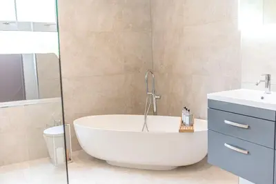 a bathroom with a tub and a toilet and a sink at Luxury townhouse in Workington in Workington