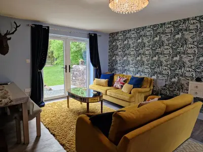 a living room with two couches and a table at The Den by Blake View Holidays a peaceful boutique retreat 3 miles from Ennerdale- standard twin or super-king bed available in Rowrah