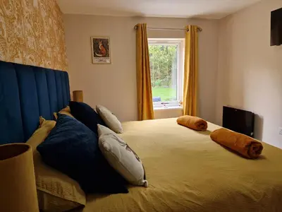 a bedroom with a large bed with pillows on it at The Den by Blake View Holidays a peaceful boutique retreat 3 miles from Ennerdale- standard twin or super-king bed available in Rowrah