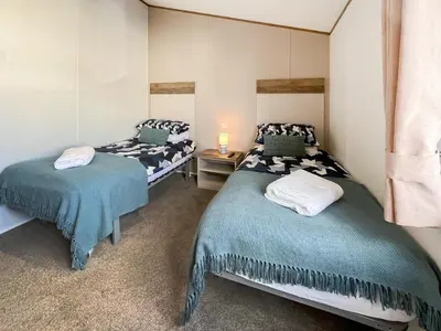 a bedroom with two beds in a room at Bud's Bay in Mainsriddle