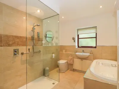 a bathroom with a shower and a sink and a toilet at The Barn at Daldorch in Mauchline