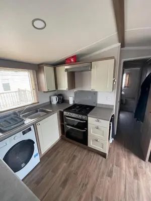 an rv kitchen with a stove and a sink at Lake District Stunning Lodge in Plumbland
