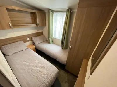 a small room with a bed and a window at Lake District Stunning Lodge in Plumbland