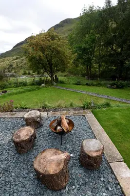 a group of logs and a bowl on a ground at Helvellyn Room With View - Double or twin in Penrith