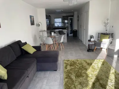 a living room with a couch and a dining room at Chapel Terrace - 2 Bedrooms - Sleeps 4 in Cleator Moor