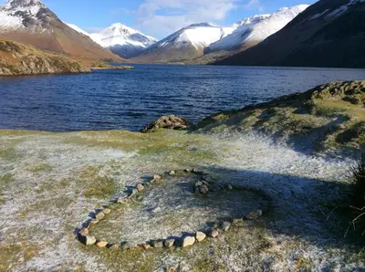 a lake with snow capped mountains in the background at Gosforth Hall Inn in Gosforth