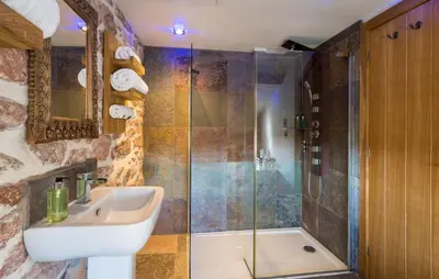 a bathroom with a sink and a shower at Gosforth Hall Inn in Gosforth