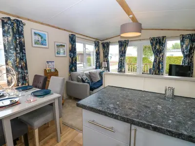 a kitchen with a table and a living room at Plot 41 in Carlisle