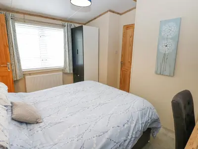 a bedroom with a bed and a window at Plot 41 in Carlisle