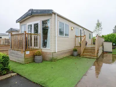 a small house with a porch and a deck at Plot 41 in Carlisle