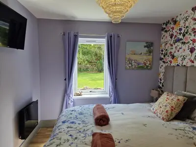 a bedroom with a bed and a window at The Stables by Blake View Holidays, comprising The Nest, The Drey, The Burrow and the Den, 3 miles from Ennerdale in Rowrah