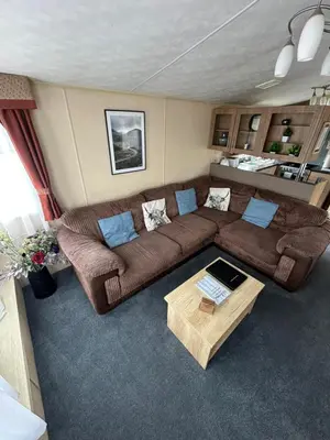 a living room with two couches and a coffee table at The Lake District Caravan in Lamplugh