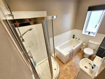 a bathroom with a shower and a toilet and a sink at Ashley House, Carlisle in Carlisle