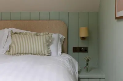 a white bed with a pillow and a lamp at Montagu in Thornhill