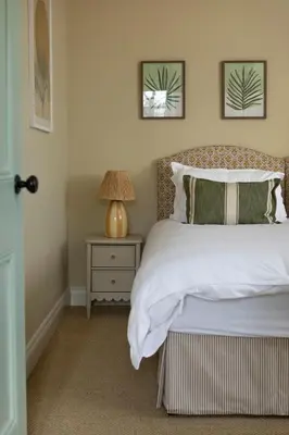a bedroom with a bed and a table with a lamp at Montagu in Thornhill